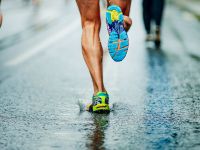 runners running on wet pavement